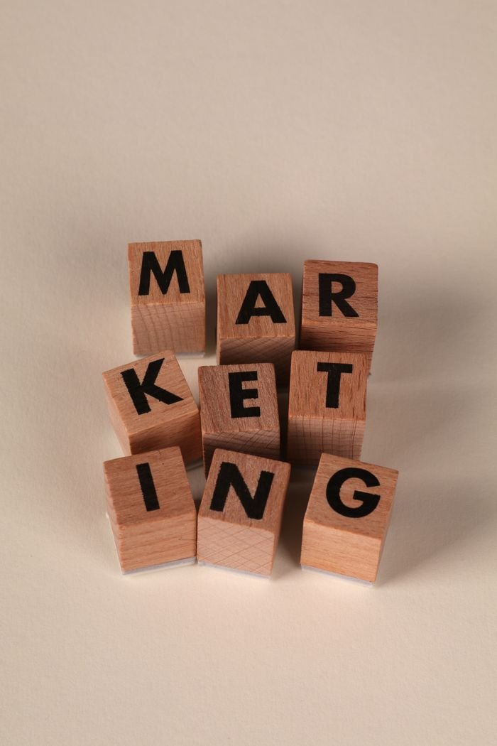about-us-02 Wooden blocks arranged to spell 'MARKETING' on a neutral background.